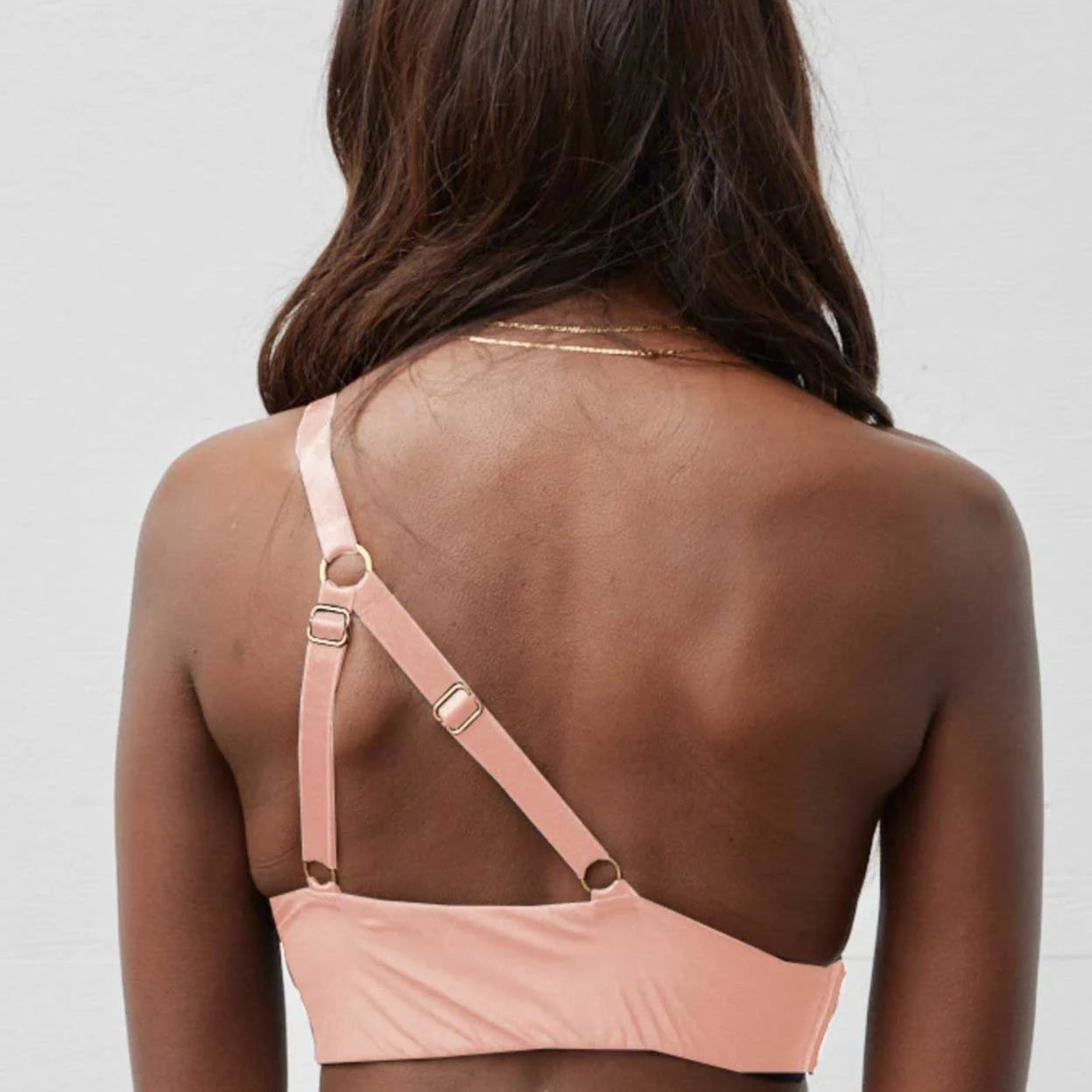 Rachel Left Unilateral Moulded Cup Sling Bra in Blush | A moulded cup bra with a side closure and intricate strap design on the back, providing stability and contours your curves for a snug and secure fit.
