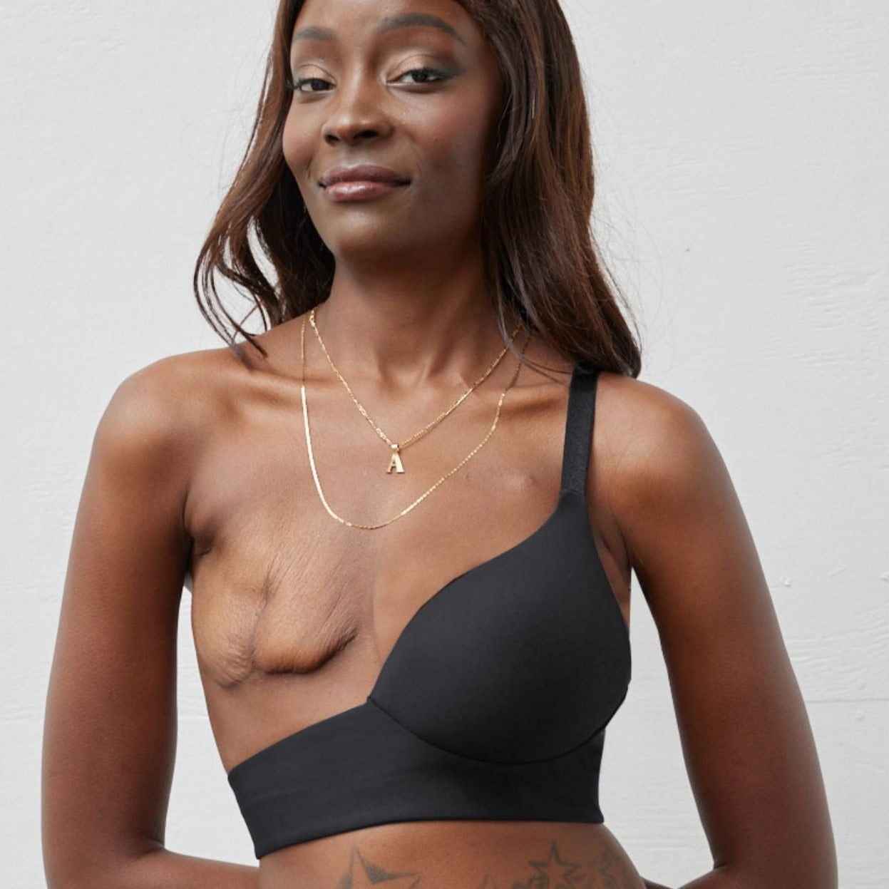 Rachel Left Unilateral Moulded Cup Sling Bra in Black | A moulded cup bra with a side closure and intricate strap design on the back, providing stability and contours your curves for a snug and secure fit.