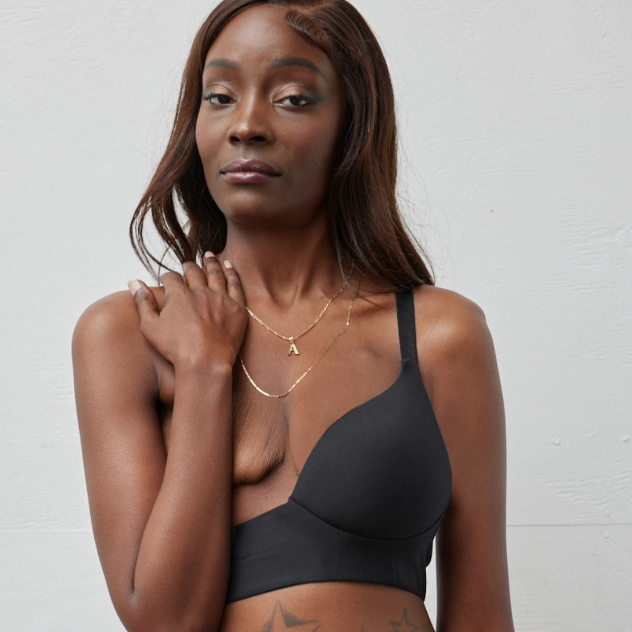 Rachel Left Unilateral Moulded Cup Sling Bra in Black | A moulded cup bra with a side closure and intricate strap design on the back, providing stability and contours your curves for a snug and secure fit.