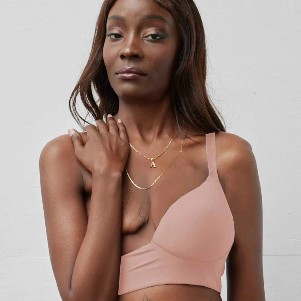 Rachel Left Unilateral Moulded Cup Sling Bra in Blush | A moulded cup bra with a side closure and intricate strap design on the back, providing stability and contours your curves for a snug and secure fit.