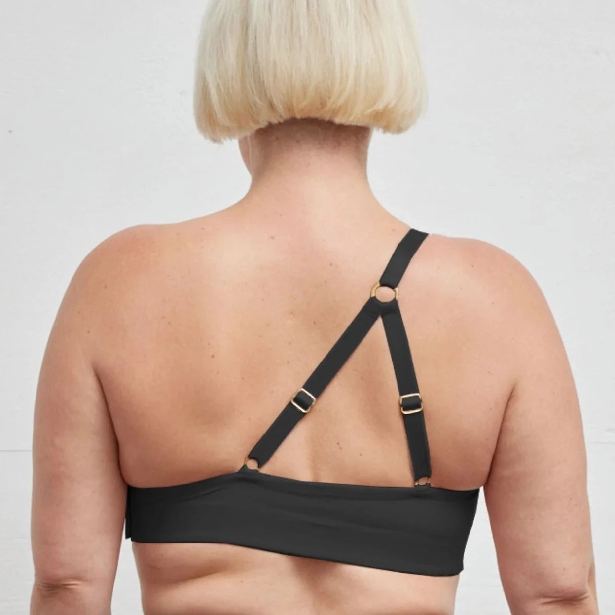 Rachel Right Unilateral Molded Cup Sling Bra in Black | A molded cup bra with a side closure and intricate strap design on the back, providing stability and contours your curves for a snug and secure fit | By AnaOno